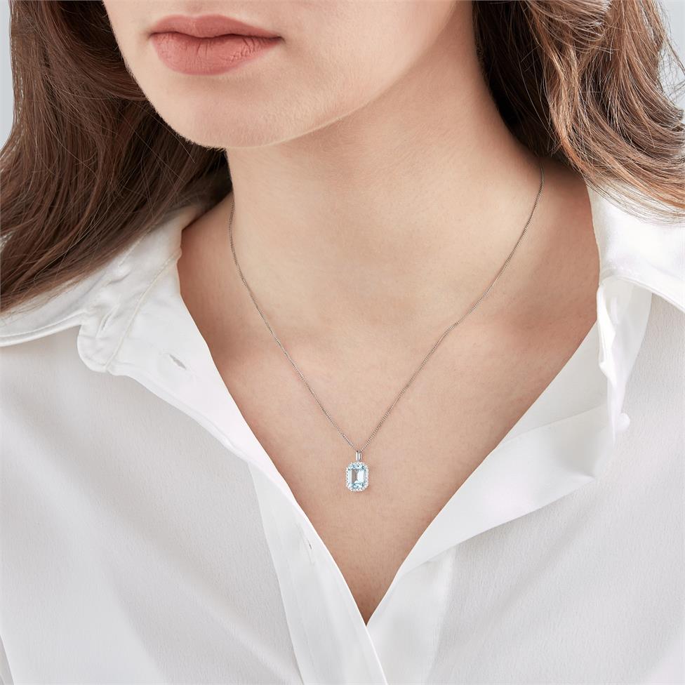 18ct White Gold Emerald Cut Blue Topaz and Diamond Halo Pendant Thumbnail Image 1